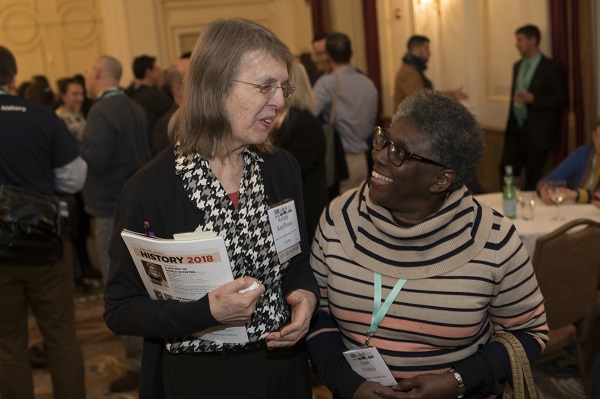 Award winner Kelsey Kauffman (left; Indiana Women’s Prison) and Joan Francis (Washington Adventist Univ.) share a laugh at the Welcome Reception.